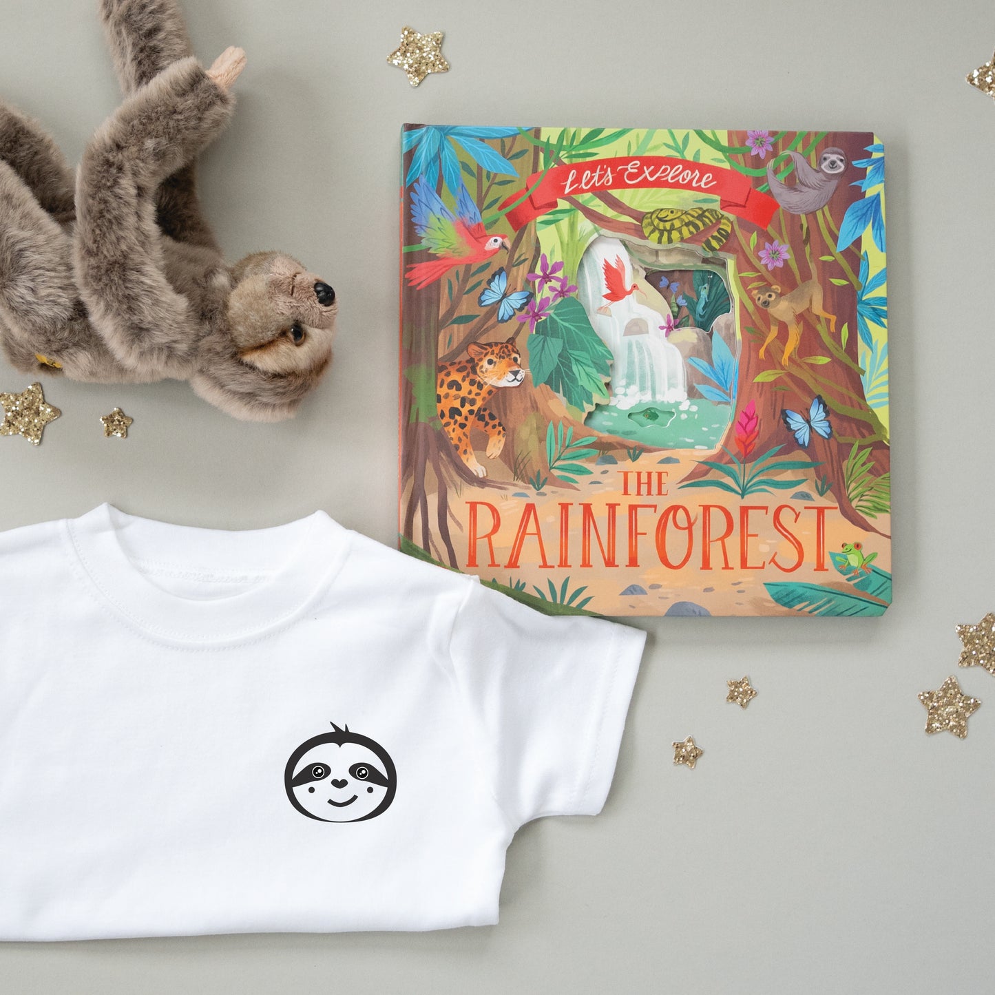 A Sloth cuddly toy, a sloth icon T-shirt and rainforest children’s book as part of a gift set